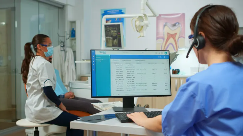 Lab customer service team member on a headset at a computer